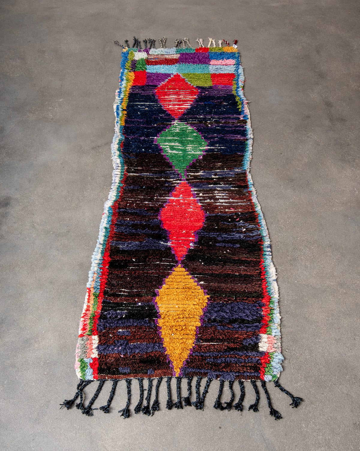 Modern designer vintage handcrafted Berber rug from Morocco. Boucherouite runner rug with beautiful colors and patterns.